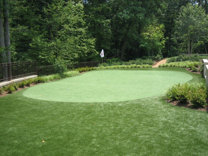 True-roll synthetic putting green installation with wooded backdrop